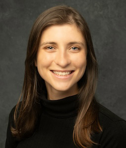 woman in black turtleneck smiling