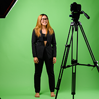 Woman standing in studio in front of green screen