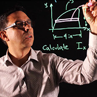 Professor writing on Board