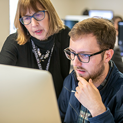 Online Teaching Faculty Toolbox Two instructors collaborating at a computer