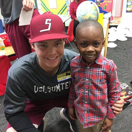 USC Sumter student with a child at a local elementary school