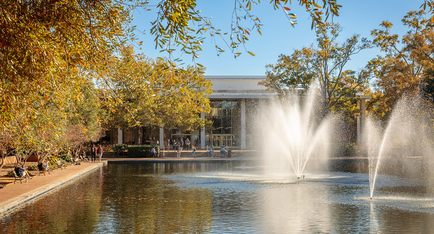 A fall day with the fountains running in the reflecting pool in front of Thomas Cooper Library.