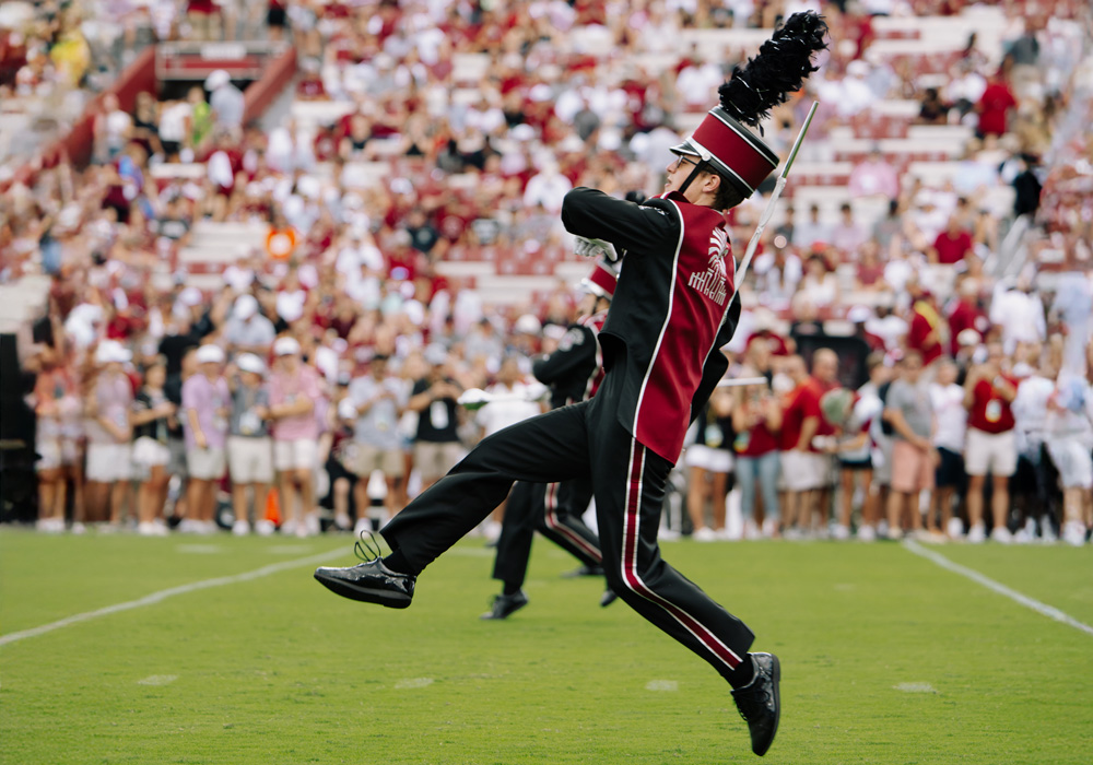 Drum major in uniform on football field during game