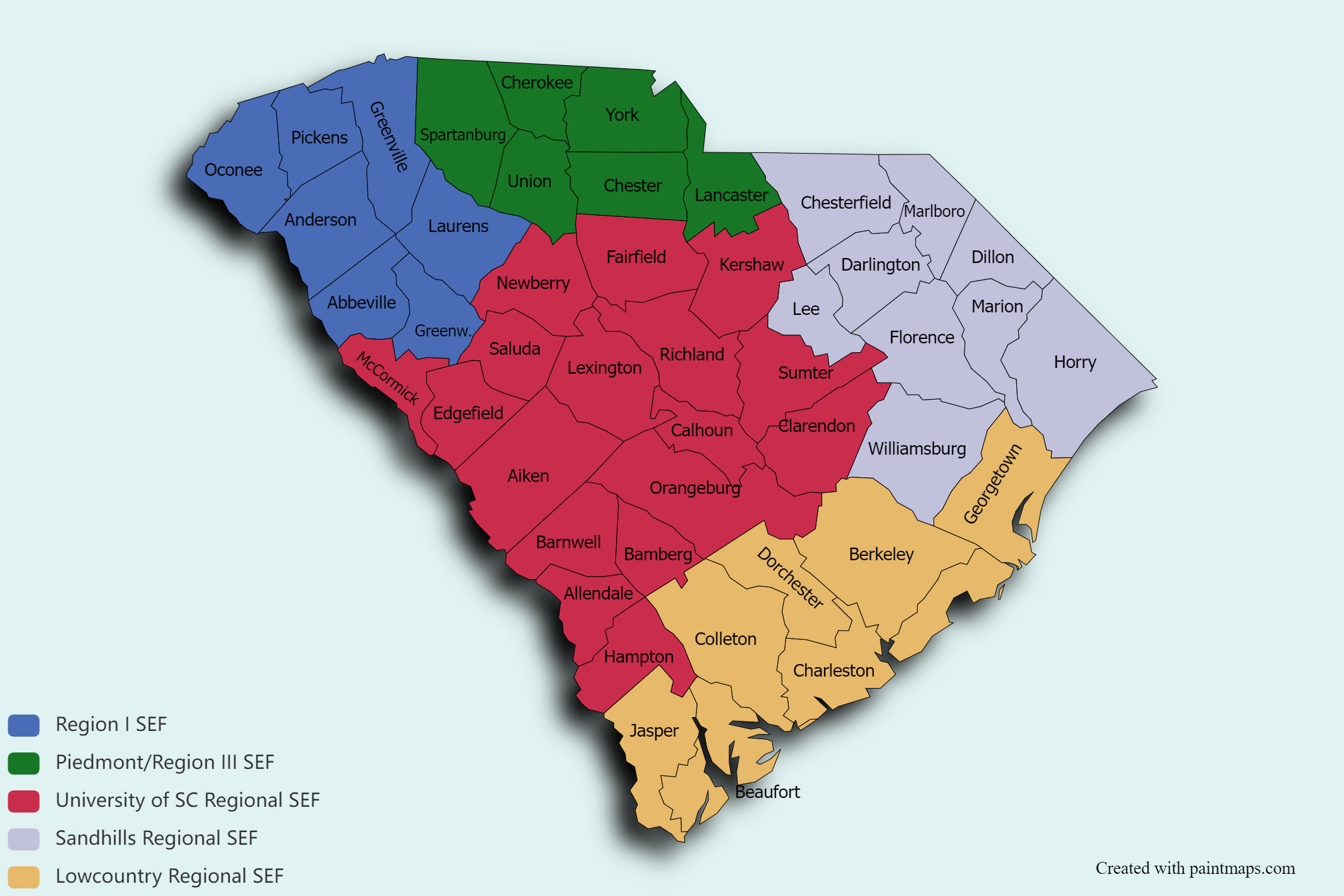 Color-coded map of South Carolina showing county-level regions for Science and Engineering Fairs (SEF). Counties are labeled by name and grouped into five regions. Region I SEF is shown in blue in the northwest and includes Oconee, Pickens, Anderson, Abbeville, Greenwood, Laurens and Greenville counties. Piedmont / Region III SEF is shown in green across the north-central part of the state and includes Cherokee, Spartanburg, Union, York, Chester and Lancaster counties. University of South Carolina Regional SEF is shown in red across the central and southwestern portions of the state and includes Newberry, Fairfield, Kershaw, Saluda, Lexington, Richland, Sumter, Clarendon, Calhoun, Orangeburg, Aiken, Edgefield, McCormick, Barnwell, Allendale and Hampton counties. Sandhills Regional SEF is shown in light purple in the east-central and northeastern part of the state and includes Chesterfield, Marlboro, Darlington, Dillon, Marion, Florence, Lee, Williamsburg and Horry counties. Lowcountry Regional SEF is shown in gold along the southern coast and includes Jasper, Beaufort, Colleton, Charleston, Dorchester, Berkeley and Georgetown counties. A legend in the lower left identifies each region by color.