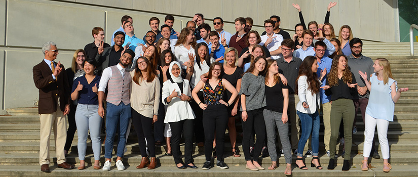 student rests her head on a poster that says Engineers!