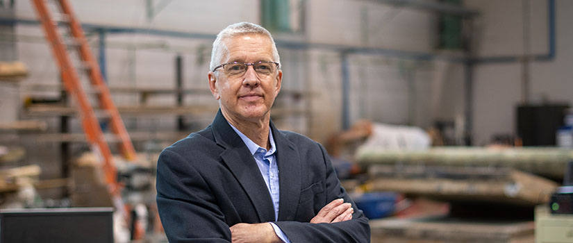 Headshot of Ziehl standing in a civil engineering lab