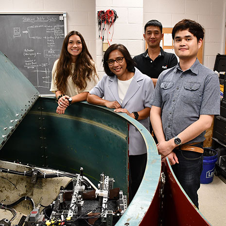 Inthuorn Sasanakul and students around the centrifuge machine