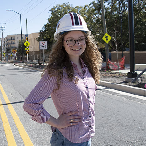 Valerie Sims standing on a road on campus