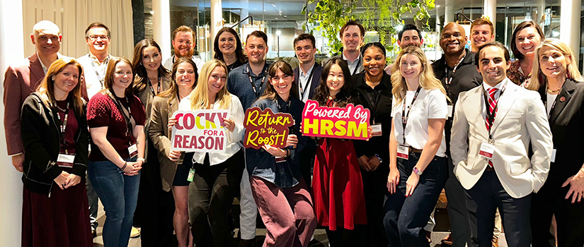 HRSM alumni, faculty and staff pose for a photo in Dallas at a reconnect event