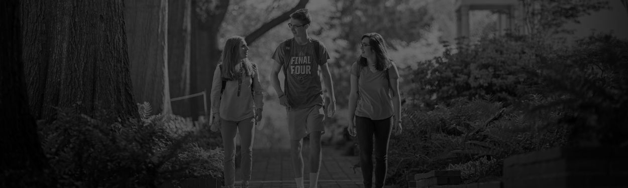 Three students walking outside on campus