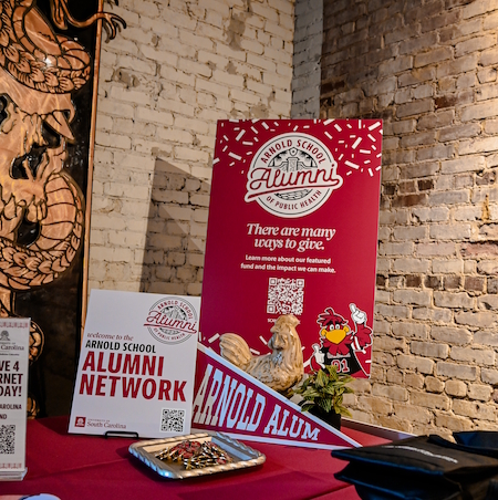 Welcome signs on a table with the main sign saying "there are many ways to give"