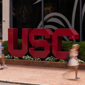 garnet block USC letters in front of Russell House